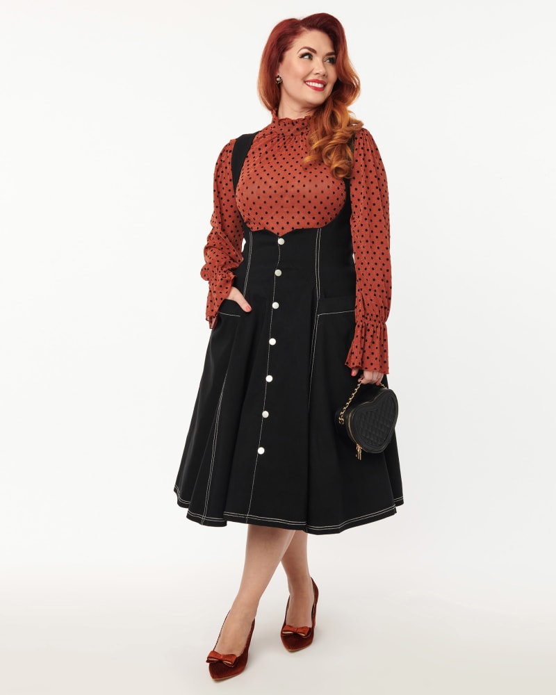 Front of a model wearing a size 5X Unique Vintage Black Denim Button Suspender Swing Skirt in Black by Unique Vintage. | dia_product_style_image_id:306025